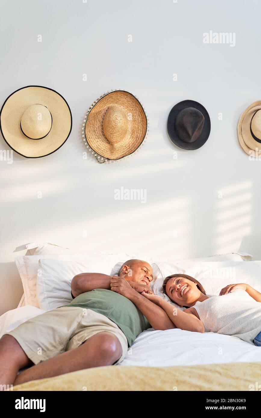 Glücklich liebevolle Paar entspannen und reden auf dem Bett Stockfoto