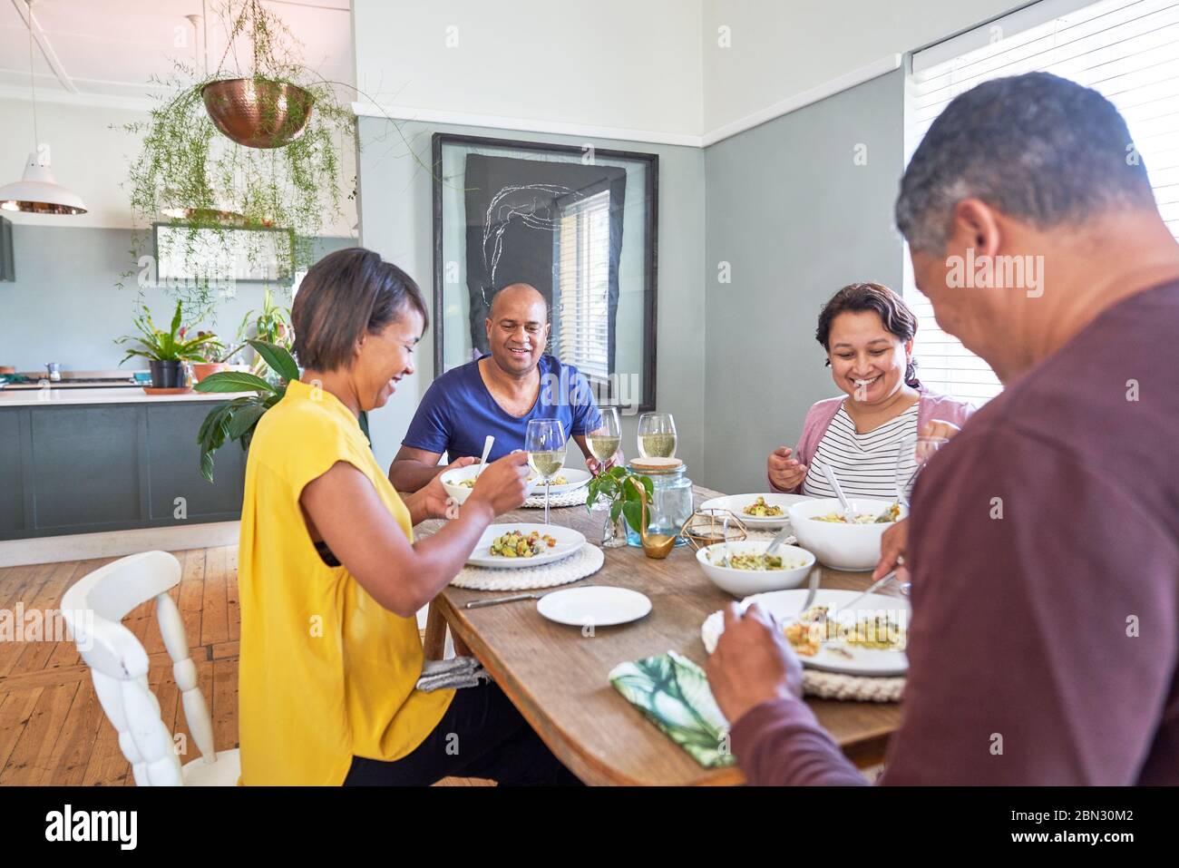 Glücklich ältere paar Freunde essen Mittagessen am Esstisch Stockfoto