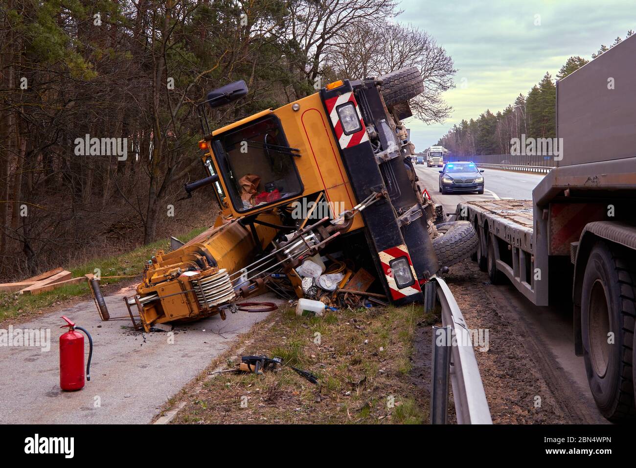 17. März 2020, Riga, Lettland: Autounfall auf der Straße, Mobilkran nach Sturz vom Anhänger, Transporthintergrund Stockfoto