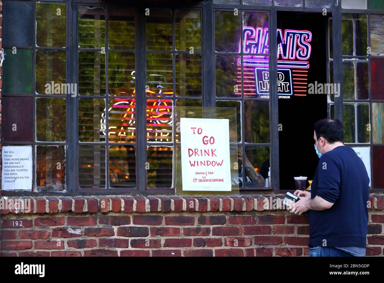 Ein 'To Go' Getränkefenster in 7B, Vazacs Horseshoe Bar im East Village Viertel von Manhattan. Aufgrund der Coronavirus COVID-19-Krise, die New York Stockfoto