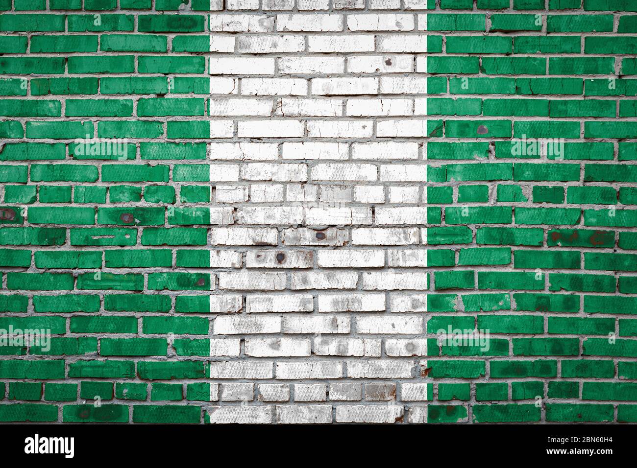 Nationalflagge Nigerias, die in Farbfarben auf einer alten Ziegelmauer abgebildet ist. Flaggenbanner auf Backstein Wand Hintergrund. Stockfoto