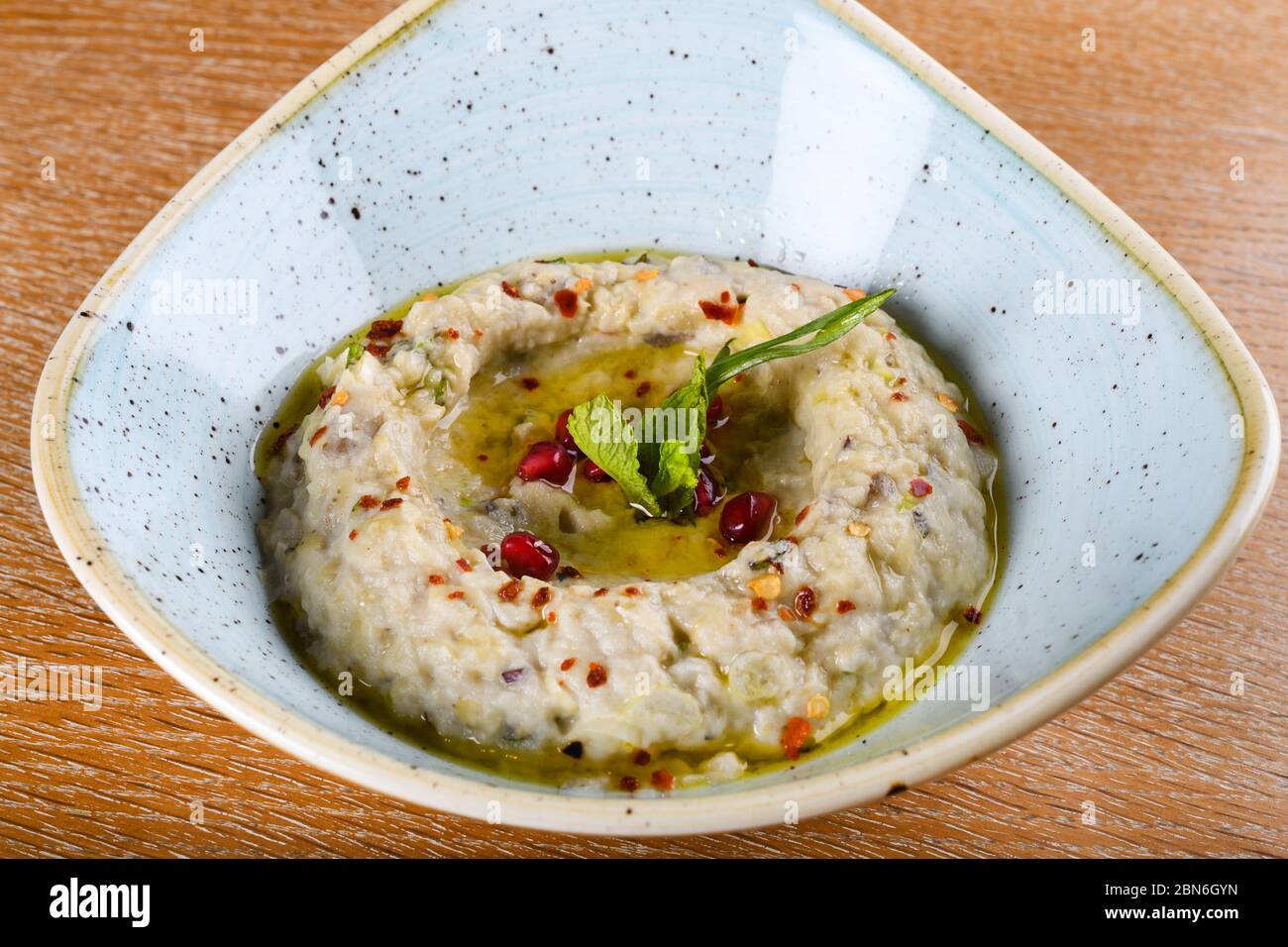 Baba Ghanoush, auch baba Ganoush oder baba Ghanouj geschrieben, ist eine Levantine Vorspeise von zermürbtem gekochten Auberginen mit Tahini, Olivenöl, möglicherweise le gemischt Stockfoto