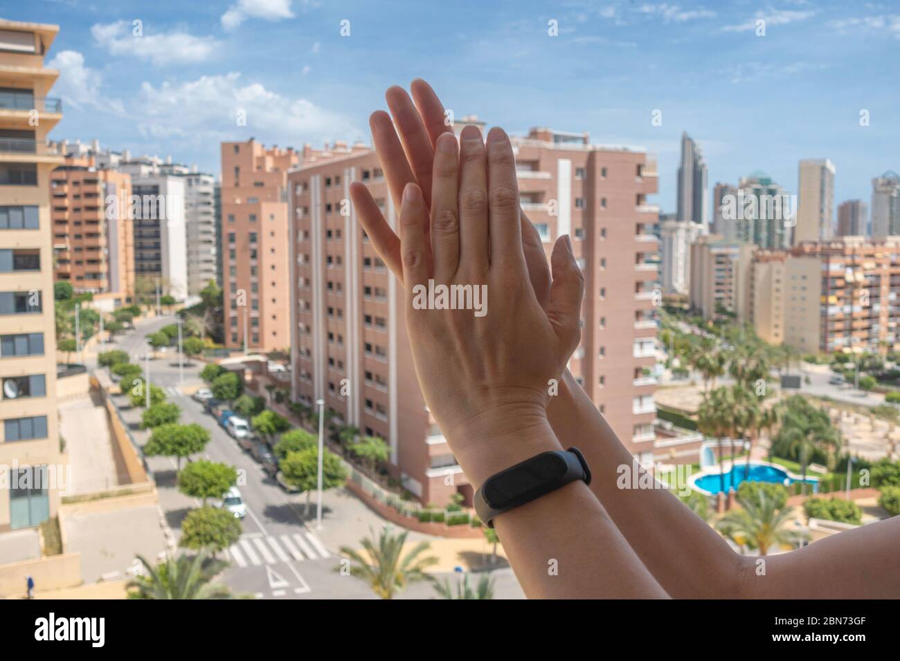 Menschen klatschen mit den Händen, applaudieren vom Balkon, um Ärzte, Krankenschwestern, Krankenhausangestellte während der Quarantäne der Coronavirus-Pandemie zu unterstützen Stockfoto