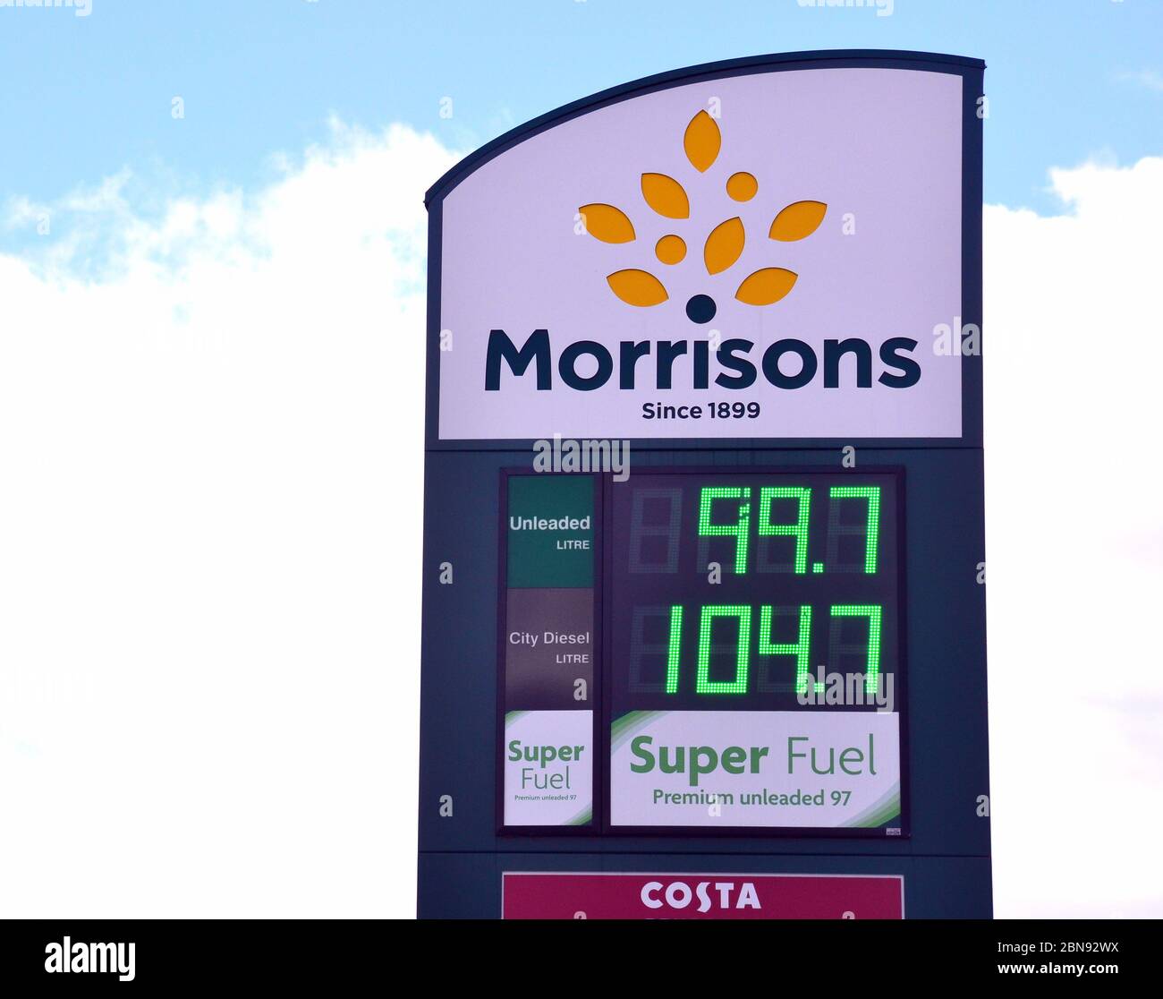 Benzin fällt unter £1 pro Liter. Ein Morrisons Tankstelle oder Garage Preisschild in Manchester, England, Großbritannien, 13. Mai 2020, zeigt bleifreies Benzin bei 99.7 Pence pro Liter. Die Ölpreise fielen im Frühjahr 2020 während der Coronavirus- oder Covid-Pandemie 19, als sie fuhren, und alle Arten von Reisen gingen weltweit zurück. Stockfoto