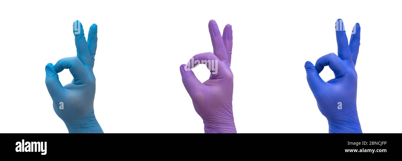 Hand mit medizinischen Handschuh, die OK-Geste, symbolisieren den Sieg über COVID-19 Stockfoto