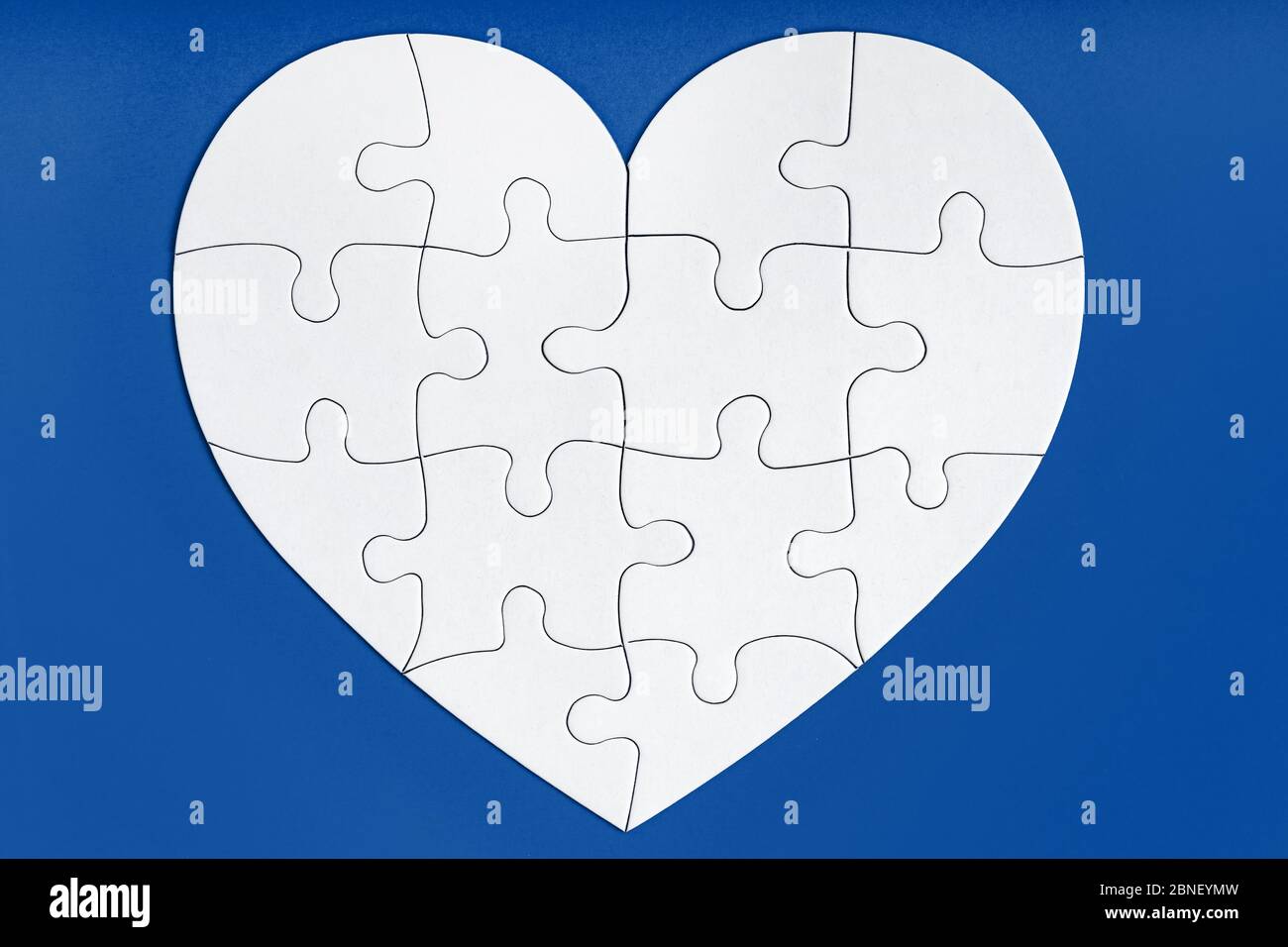 Puzzle-Teile in Form von Herz auf blauem Hintergrund. Liebe, Nächstenliebe, Spende, helfende Konzept. Perfekt abgestimmt, Wiedersehen. Stockfoto