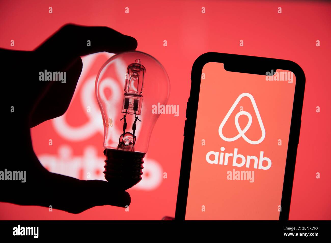 LONDON, UK - Mai 15 2020: Airbnb-Logo für die Vermietung von Ferienmietwohnheims auf einem Telefon mit Glühbirne Stockfoto