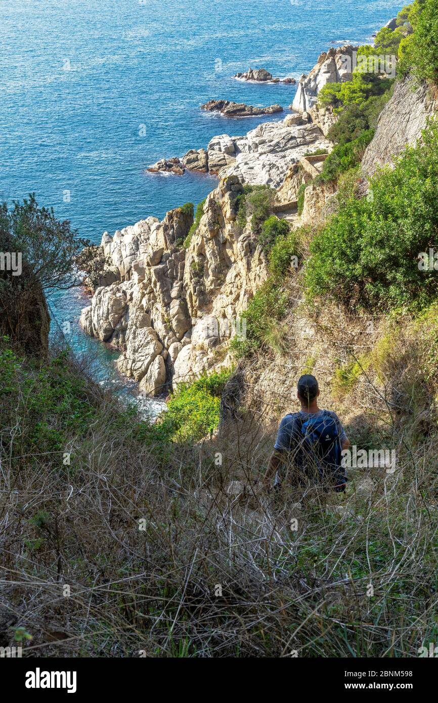 Europa, Spanien, Katalonien, Costa Brava, Lloret de Mar, Wanderer genießen den Blick entlang der Küste auf dem Camí de Ronda Fernwanderweg an der Costa Brava Stockfoto