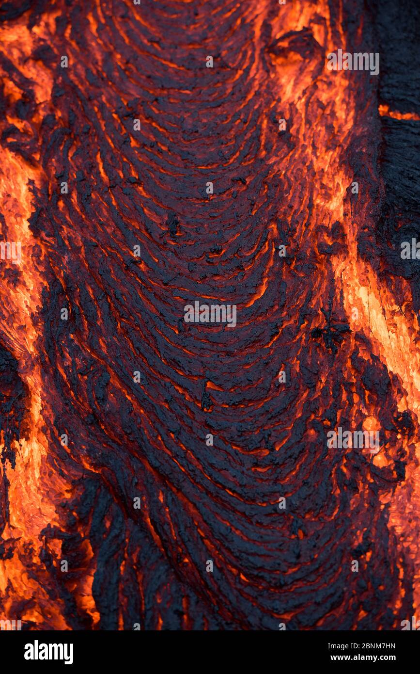 Pahoehoe Lava aus dem 61G-Fluss, der von Pu'U O'o auf dem Kilauea Vulkan ausgeht, sickert von einem Ausbruch in der Nähe des Kamokuna Ozeaneintritts in Hawaii Vulkane Stockfoto