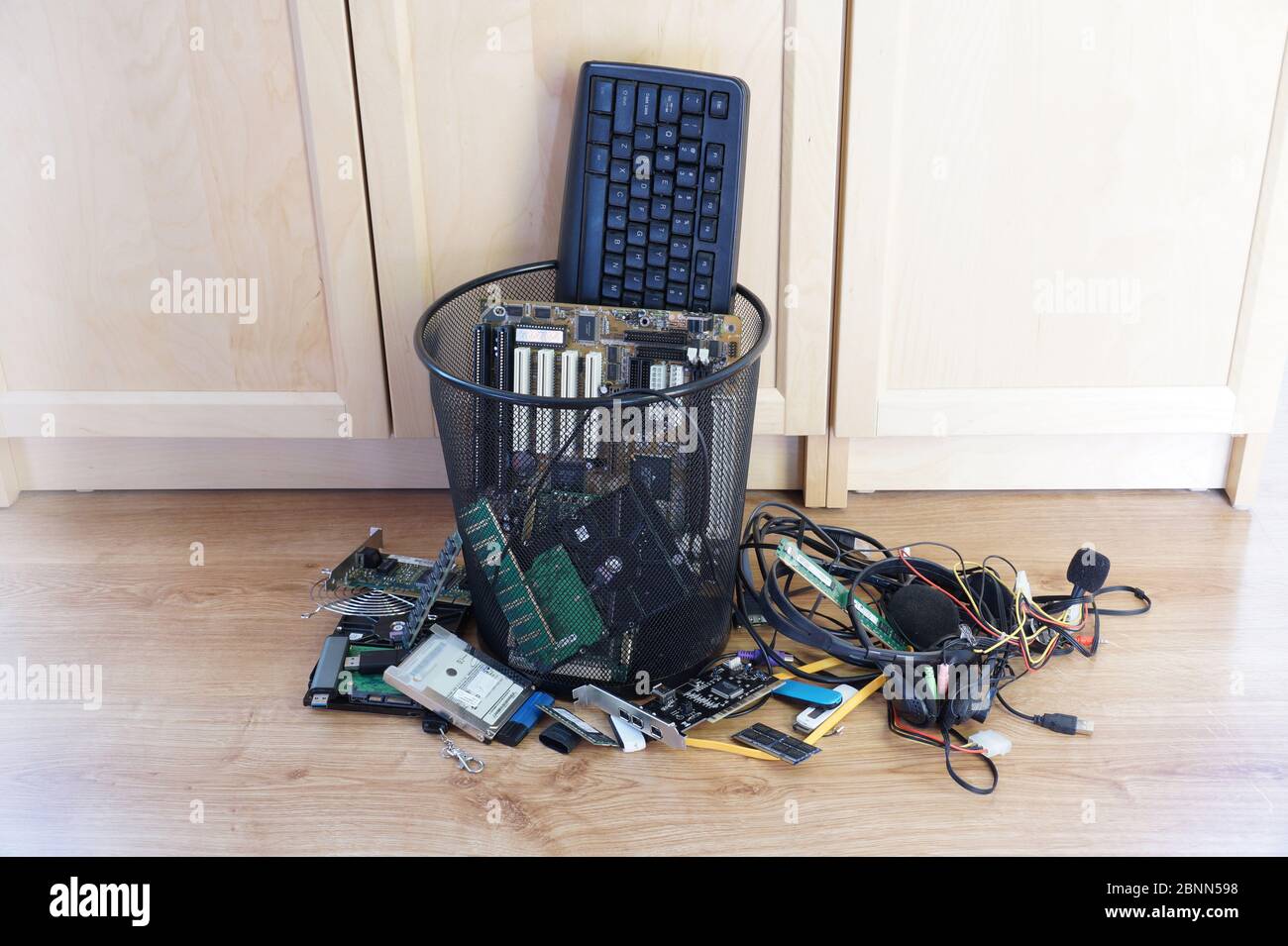Ein Mülleimer, der mit abgenutzten Computerkomponenten gefüllt ist. E Ausschuss. Stockfoto