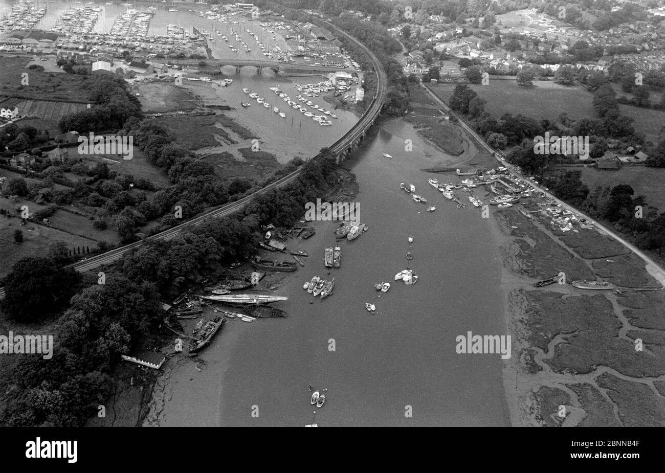 AJAXNETPHOTO. 1979. BURSLEDON, ENGLAND. - YACHTING MEKKA - LUFTAUFNAHME DES BERÜHMTEN HAMBLE FLUSSES, DER SICH SÜDWESTLICH IN RICHTUNG SOUTHAMPTON WATER UND SOLENT SCHLÄNGELT. IM VORDERGRUND IST DIE BURSLEDON-EISENBAHN, DIE DAS VIADUKT MIT DER A27-STRASSENBRÜCKE IN DER MITTE RECHTS ÜBERQUERT.FOTO:JONATHAN EASTLAND/AJAX REF:1979 4055 Stockfoto