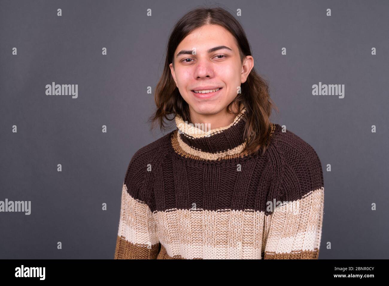 Junger androgyner Mann mit langen Haaren bereit für den Winter Stockfoto