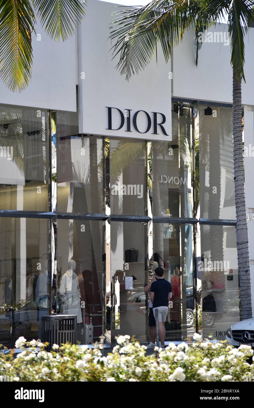 Beverly Hills, CA/USA - 8. Mai 2020: Mann, der in den Fenstern des Dior-Geschäfts auf dem Rodeo Drive schaut, der während der COVID-19 Quarantäne geschlossen ist Stockfoto