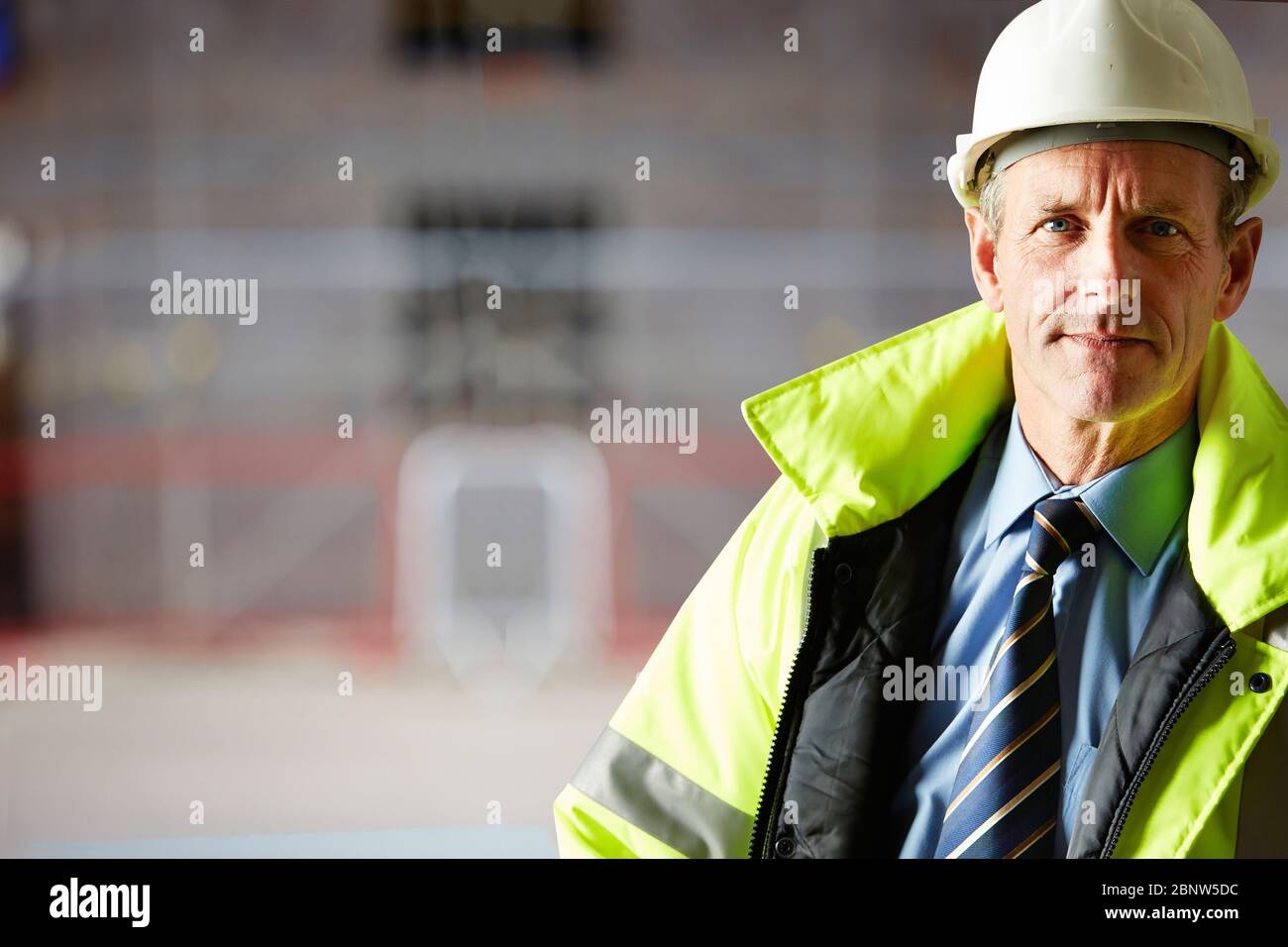 Porträt des selbstbewussten Architekten, der auf der Baustelle einen Hardhat trägt Stockfoto