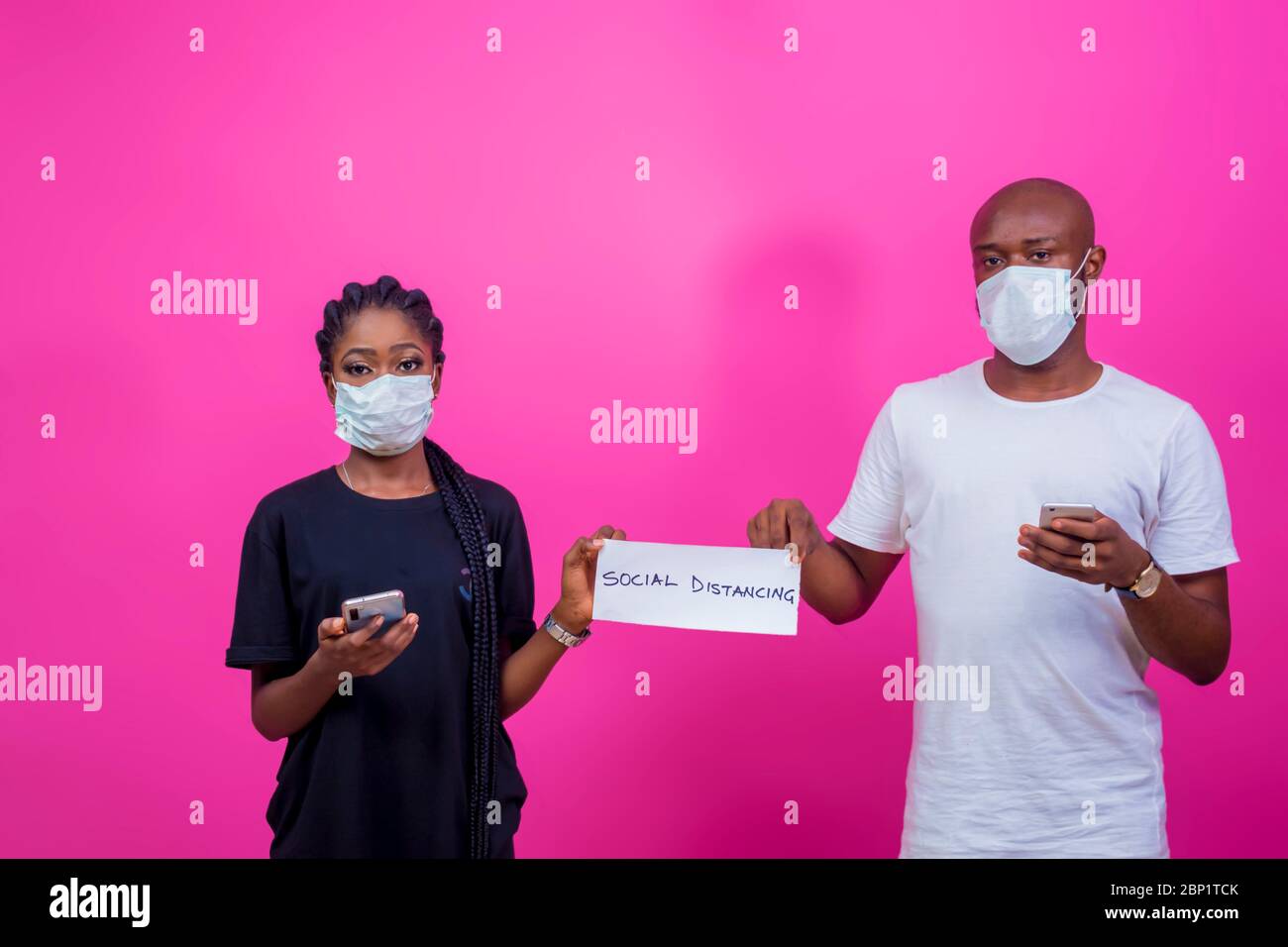 Zwei junge schwarze Menschen praktizieren und erziehen Menschen auf soziale Distanz Stockfoto