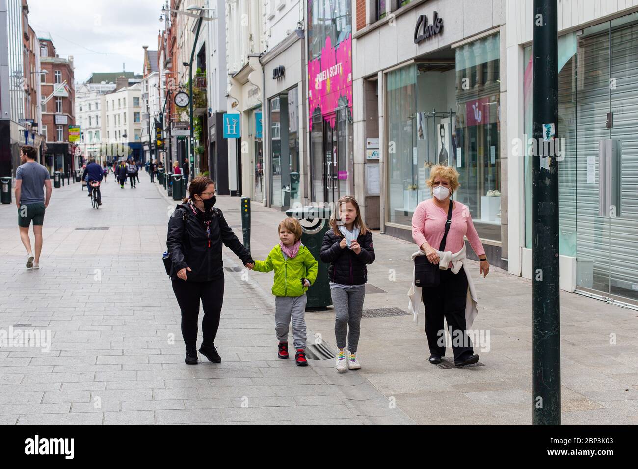 Familie, die durch eine ruhige Grafton Street im Stadtzentrum von Dublin spazieren, während der Fußabsturz aufgrund einer Coronavirus-Pandemie abstürzt. Civid-19 in Irland. Stockfoto