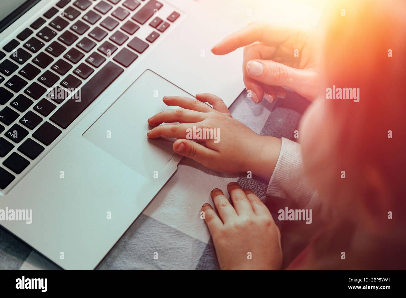 Mama zeigt Kind, wie man Computer benutzt Stockfoto