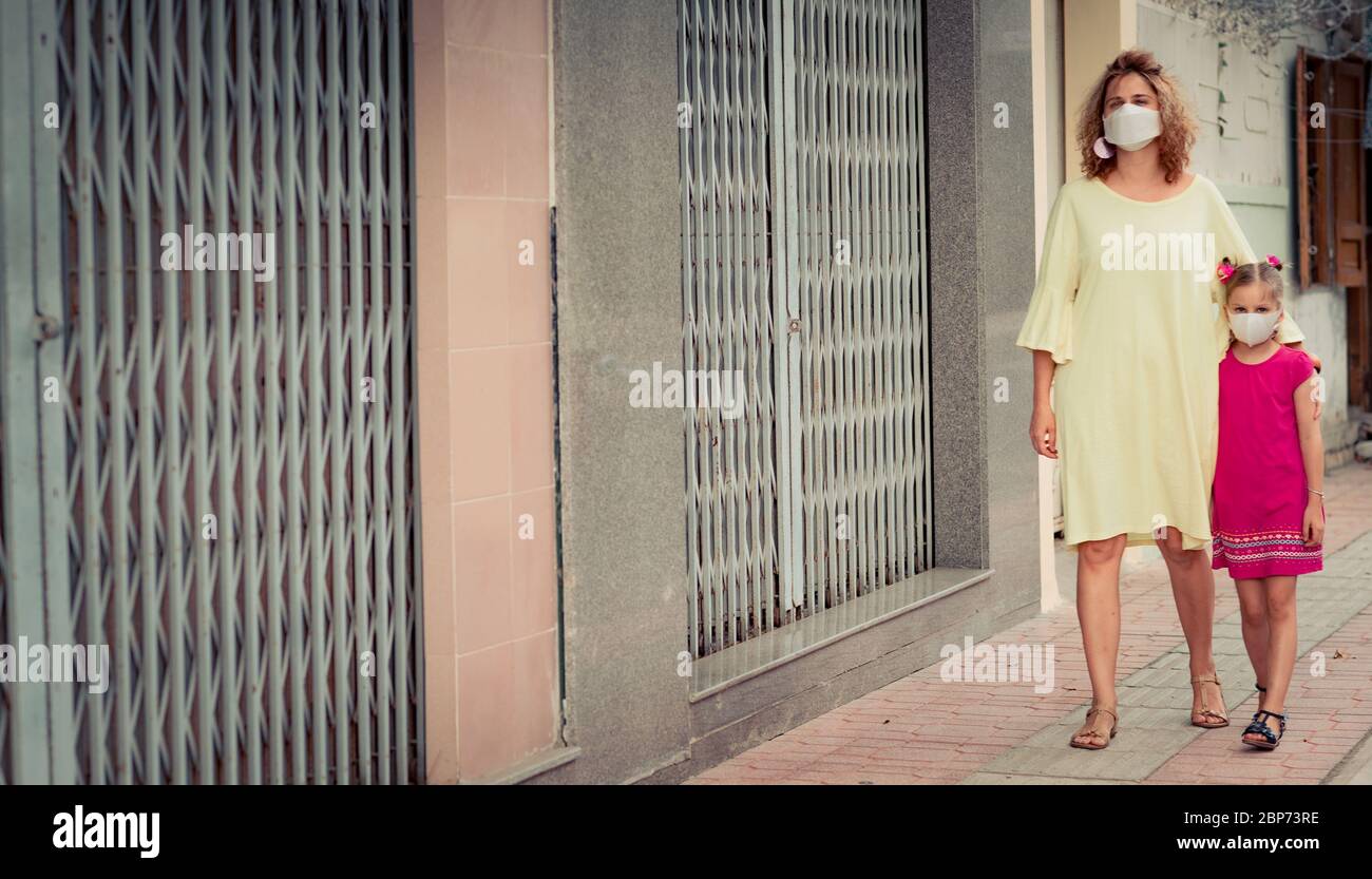 Frau und Tochter tragen eine Einwegmaske, um Virusinfektionen zu vermeiden. Schutz vor Coronavirus Stockfoto