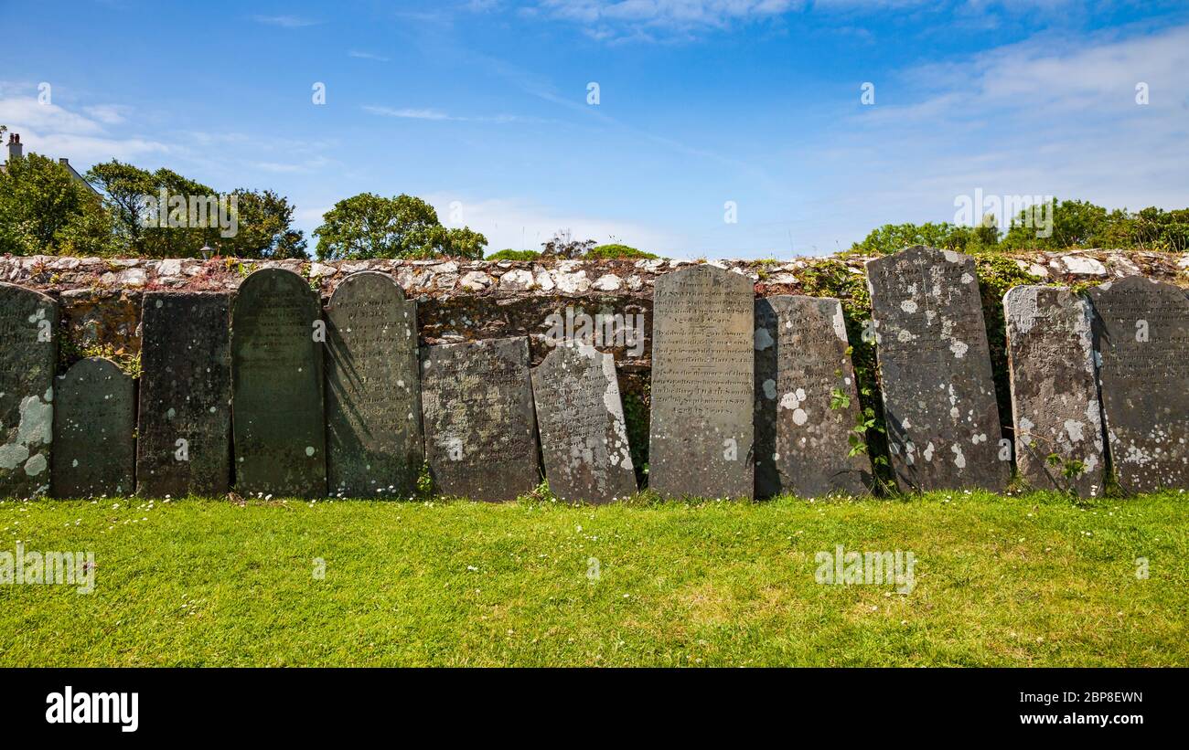 Verwitterte Grabsteine an der Außenmauer zur Saint Davids Cathedral, Pembrokeshire, Wales Stockfoto