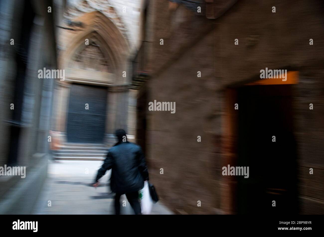 Eine Person geht die Straße Mirallers entlang, die gegenüber der Kathedrale von Santa Maria del Mar, Ghotic Viertel, Barcelona beginnt. Stockfoto