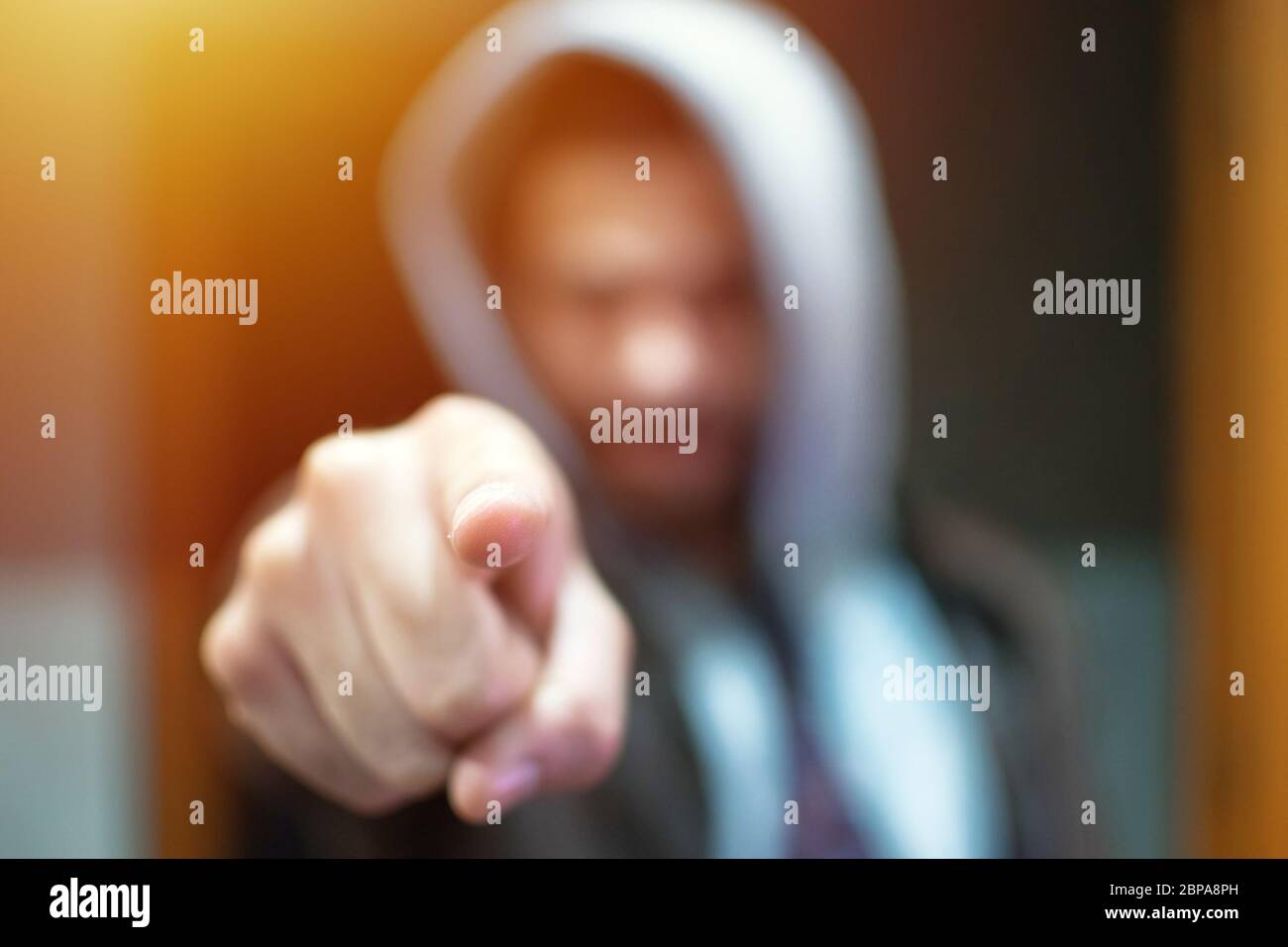Anonymer und gesichtsloser Mann unter Hoodie Zeigen Finger auf Kamera isoliert - Inkognito und geheimnisvollen kriminellen auf Internet-Aktivitäten Konzept. Stockfoto