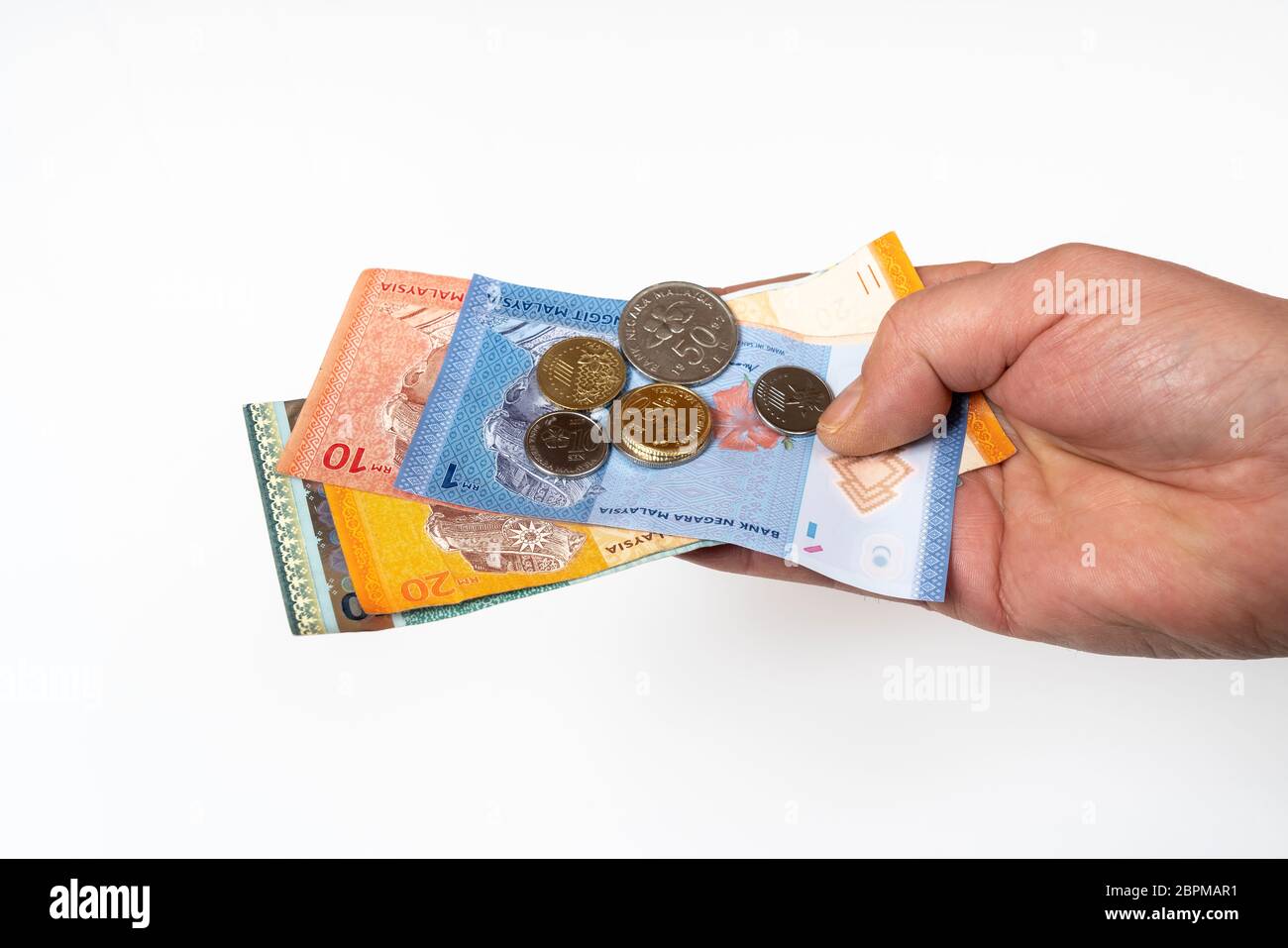 Einige malaysische Ringgit Banknoten und Münzen in der Hand Stockfoto