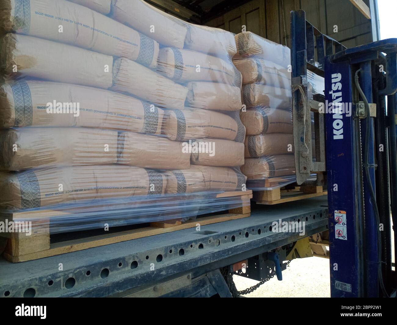 Krasnodar, Russland - 13. Juni 2019: Entladen von Säcken aus Zement von einem LKW mit einem Gabelstapler. Stockfoto