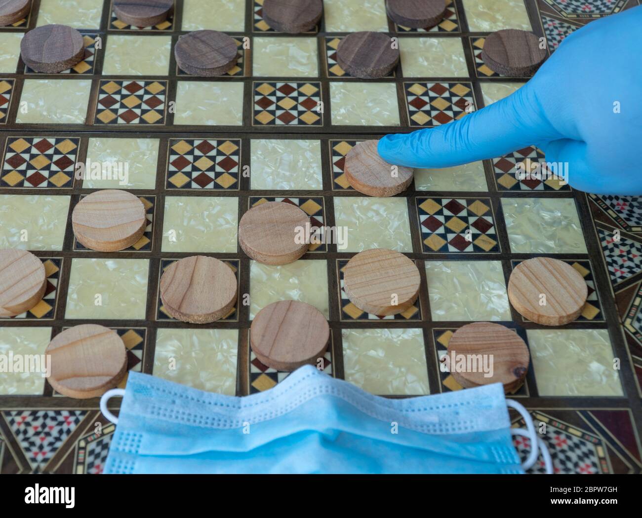 Quarantäne wegen Coronavirus COVID-19 Pandemie. Durchführung von Aktivitäten auf der Quarantäne. Brettspiel der Dame. Stockfoto