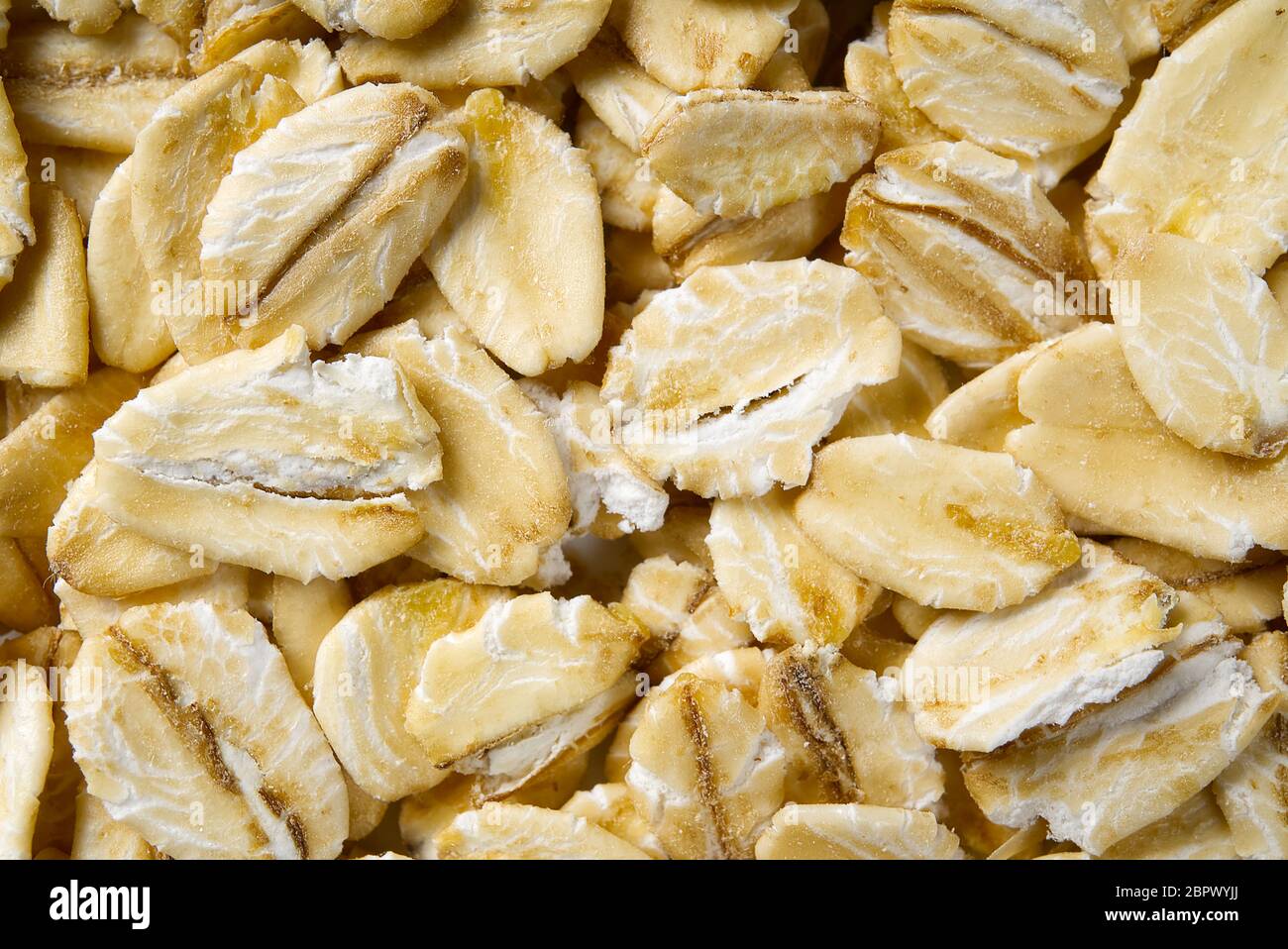 Nahaufnahme von Haferflocken. Haferflocken Makro schießen. Haferflocken Textur. Hintergrund der goldenen Haferflocken. Gesunde Ernährung. Stockfoto