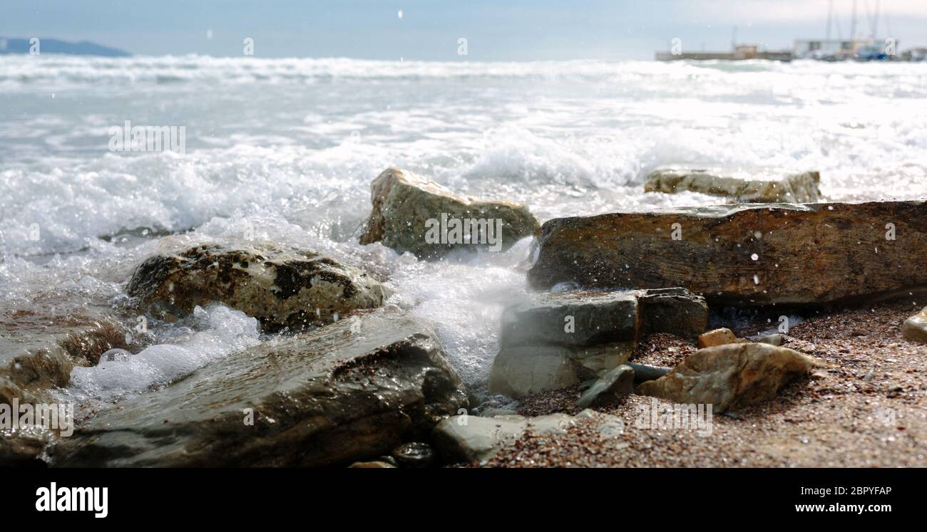 Schaumig Wellen Rollen auf felsigen Strand Stockfoto