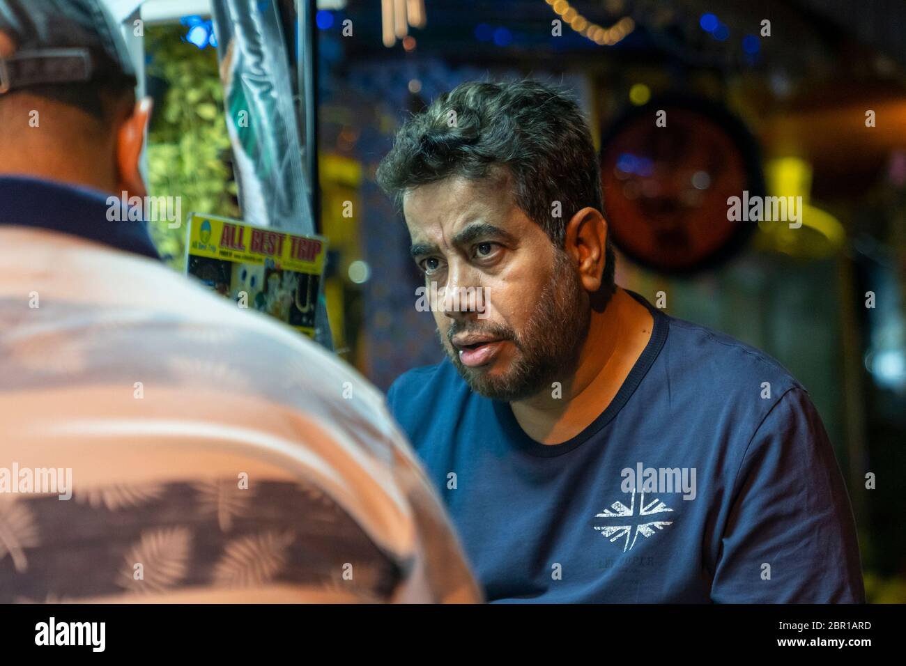 Thailand, Phuket, 15. März 2020: Thailand, Phuket, 30. März 2020: Ein bärtiger Erwachsener auf einer Straße in Thailand spricht mit einer anderen Person. Nahaufnahme Stockfoto