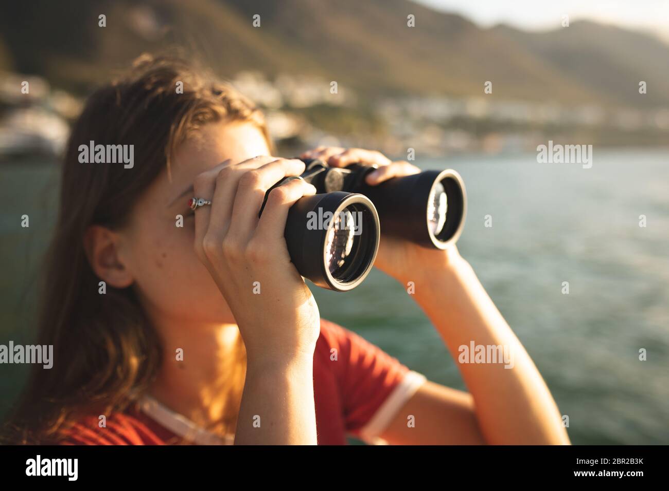 Ein Mädchen im Kaukasus, das Ferngläser hält und benutzt Stockfoto