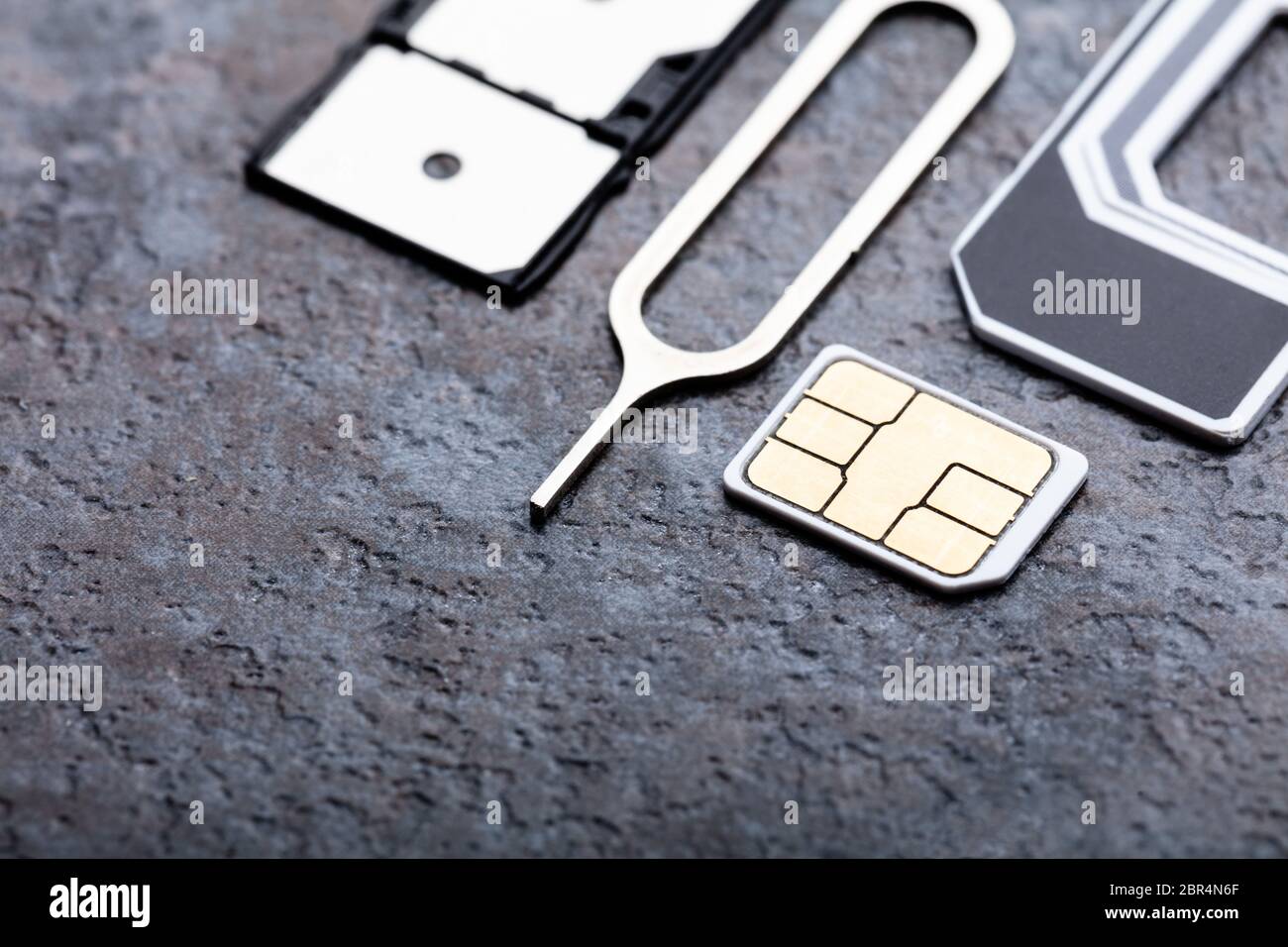 Nano-SIM-Karte in den Card Adapter mit Eject Pin auf Betonoberfläche Stockfoto