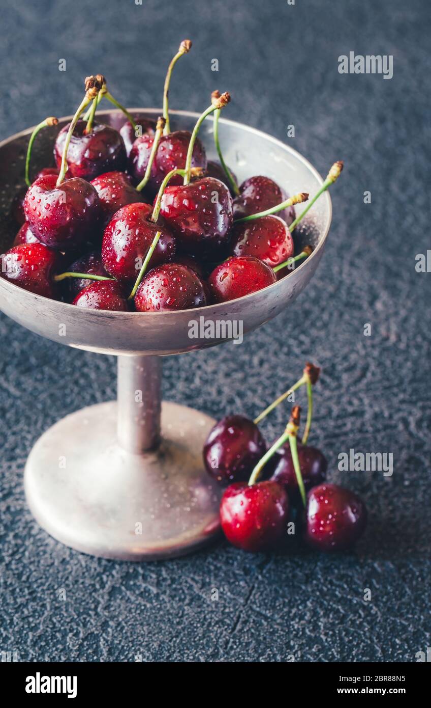 Frische Kirschen in Vintage silver Vase auf dem dunklen Hintergrund Stockfoto