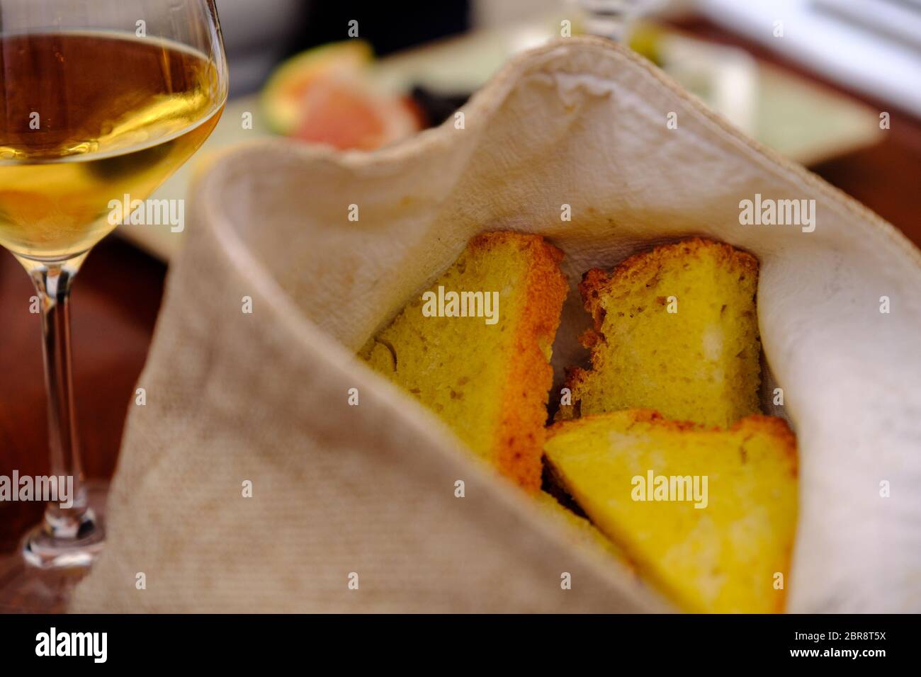 Korb mit Brot und einem Glas Weißwein auf einer kroatischen Tisch Stockfoto