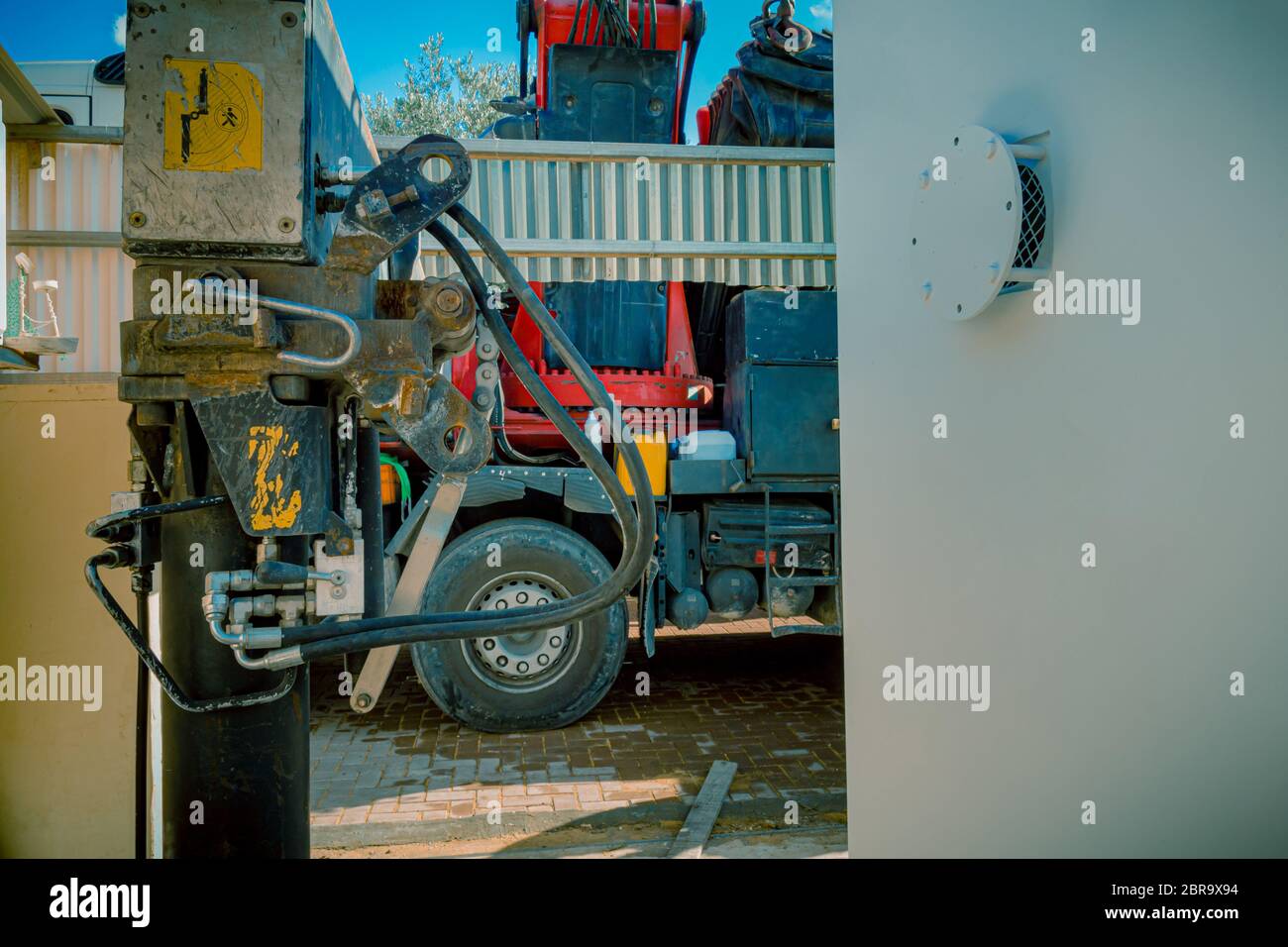 Nahaufnahme der hydraulische Kolben eine takelage mit schweren Lkw Kran arm Maschine. Es ist geparkt in der Nähe eines Wohn- oder Gewerbegebiet mit Stockfoto