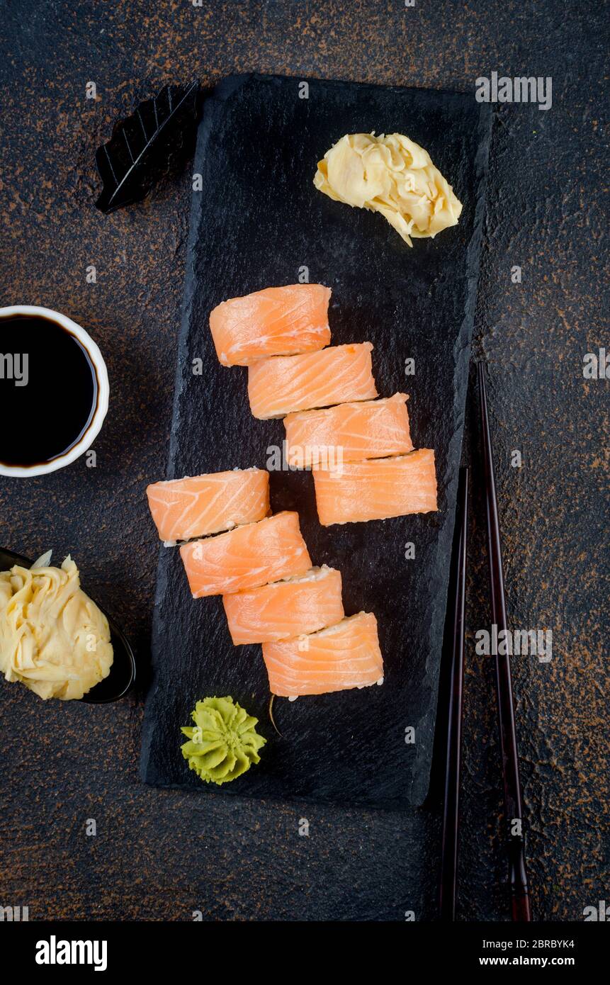 Philadelphia Roll Sushi mit Lachs und Frischkäse auf schwarzem Steinteller Stockfoto