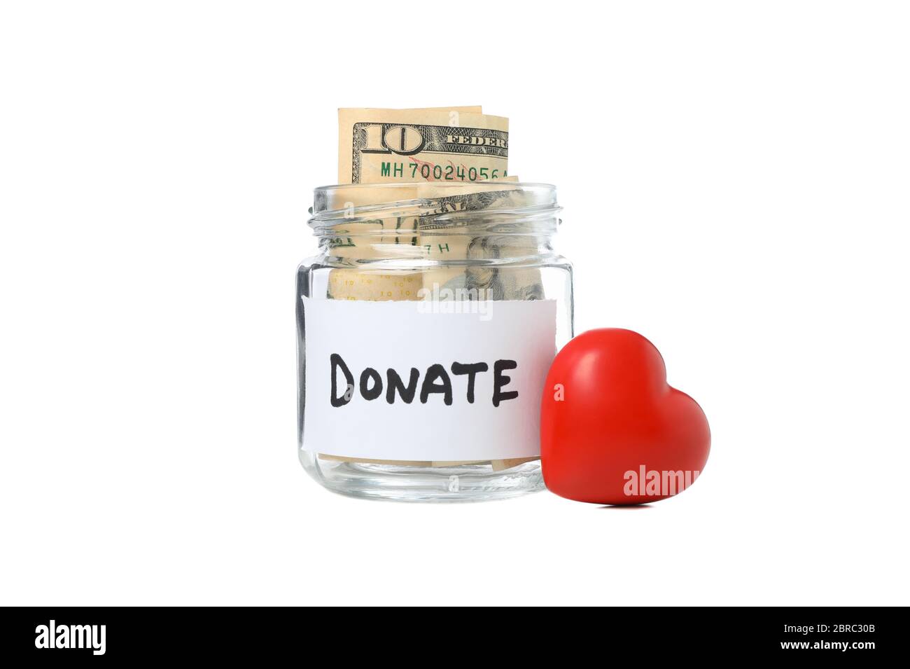 Herz und spenden Glas Glas mit Geld isoliert auf weißem Hintergrund Stockfoto