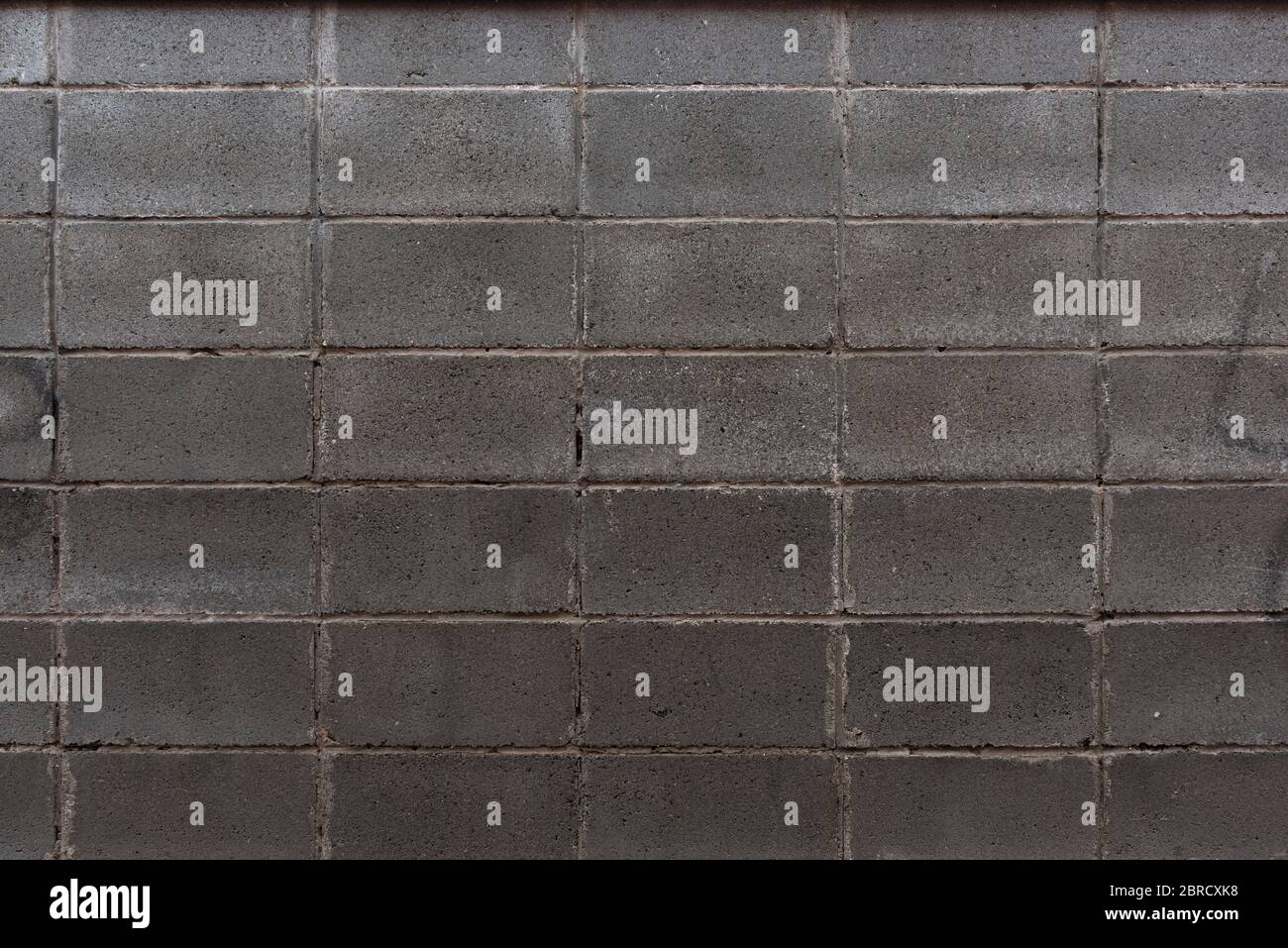 Mauerwerk Wand aus grauem rechteckigem Stein Stockfoto