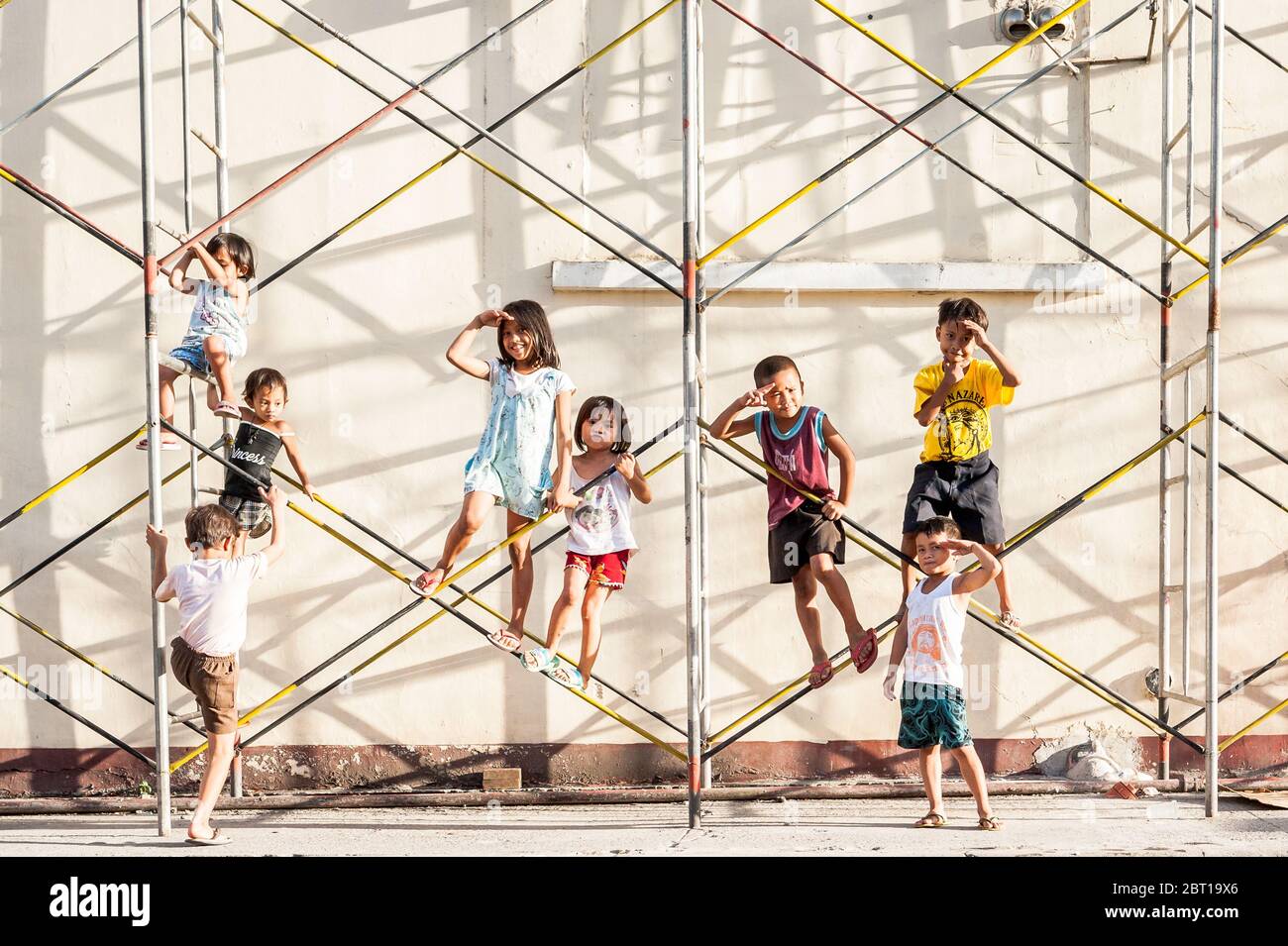 Philippinische Kinder spielen auf Gerüsten in der alten ummauerten Stadt Intramurous, Manila, Philippinen. Stockfoto