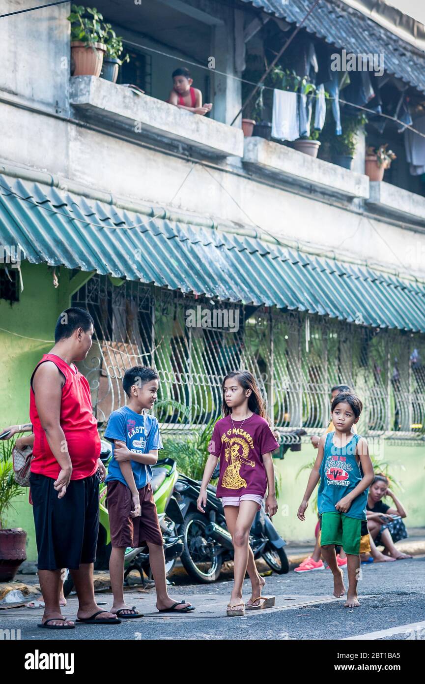 Familien und Kinder schlendern durch die Straßen der alten Stadtmauer Intramuros Manila, Philippinen. Stockfoto