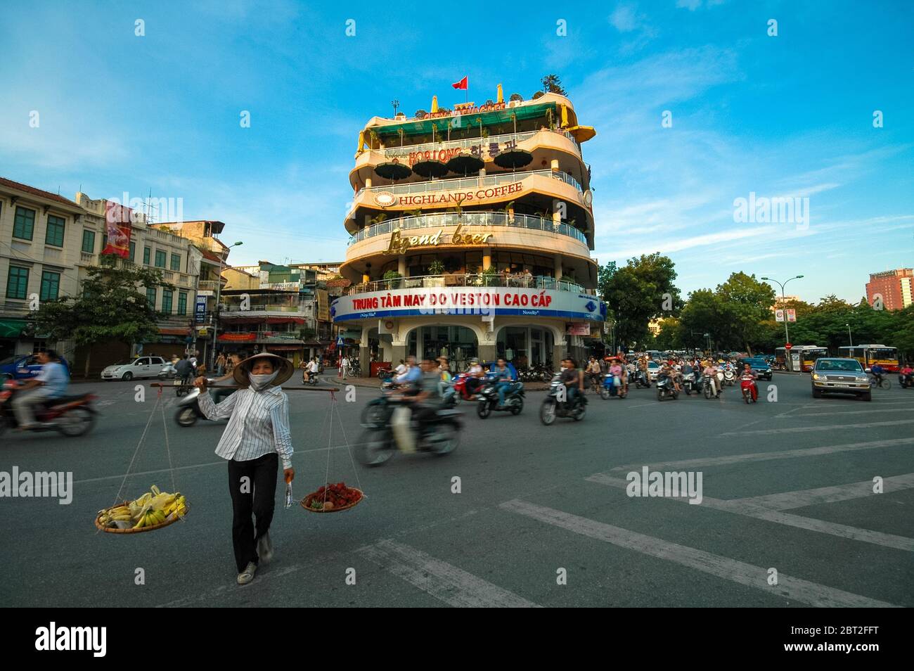 Frau trägt Korb auf Schulter in Hanoi, Vietnam Stockfoto