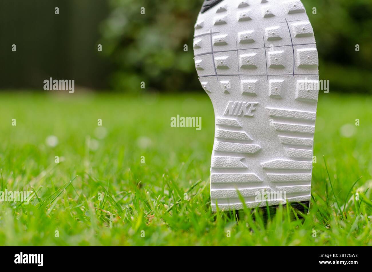 Das Nahaufnahme Foto der Air Nike Trainingssohle für Kinder auf dem lebhaften Gras. Für die Bildgebung wurde ein flaches Sichtfeld verwendet. Stockfoto