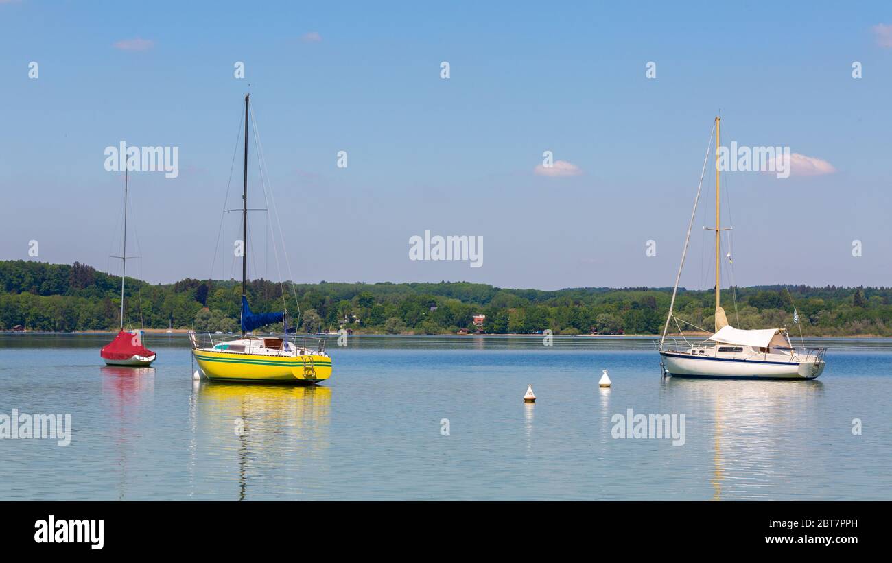 Idyillisches Panorama des Ammersee mit ankenden Segelbooten. Blauer, klarer Himmel. Der Ammersee ist ein beliebtes Ausflugsziel. Stockfoto