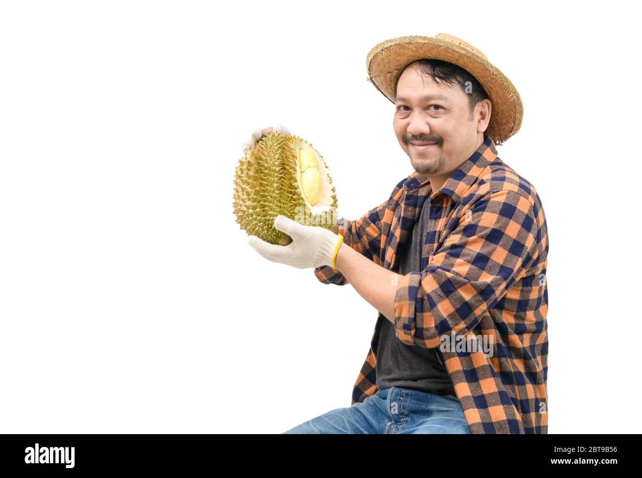 Glücklicher Bauer trägt Durian und lächelnd isoliert auf weißem Hintergrund. Weil es zu einem sehr guten Preis auf dem Markt verkauft werden kann, König der Früchte an Stockfoto