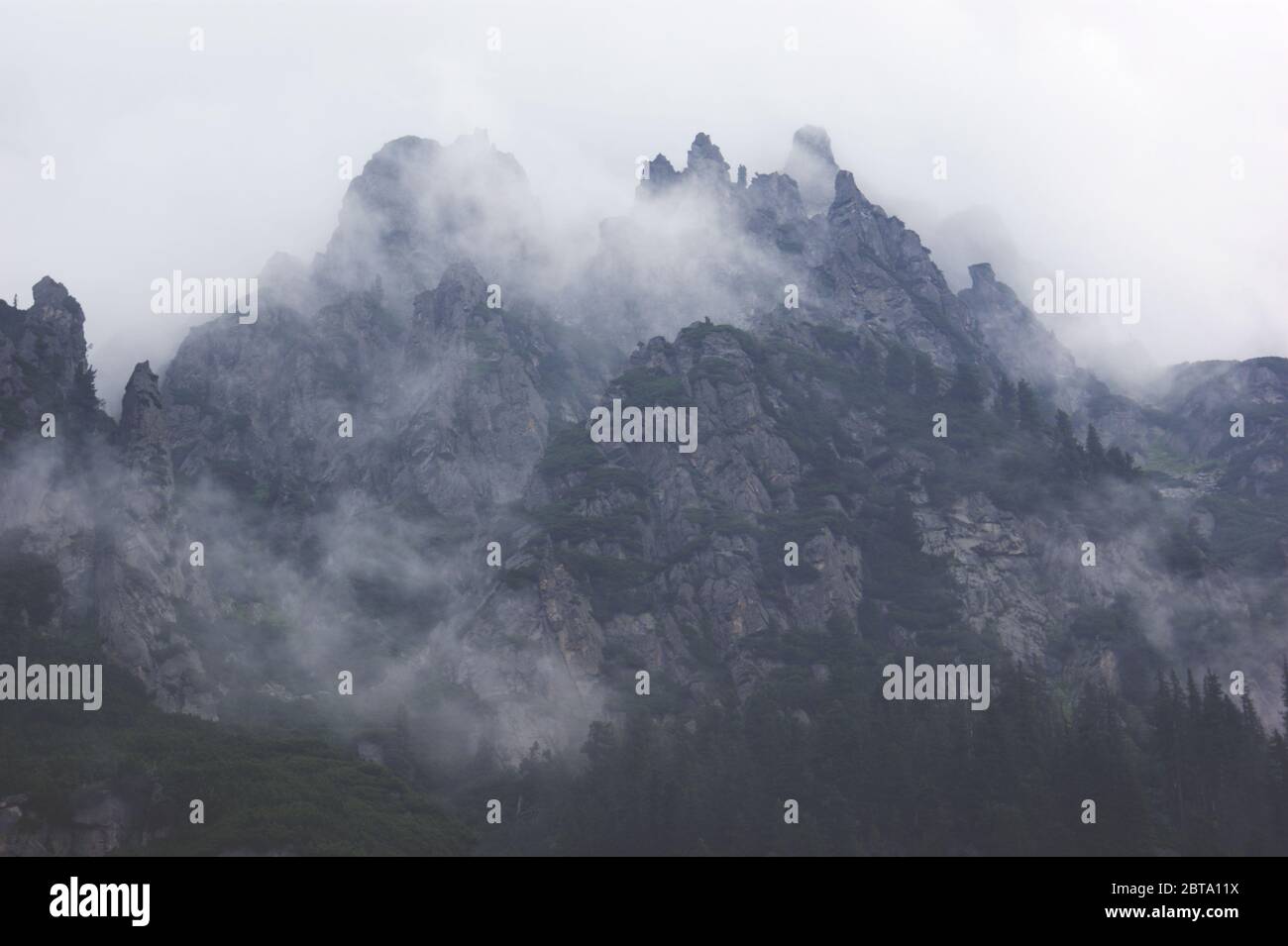 Dunkle Berge im Nebel und Wolken Stockfoto
