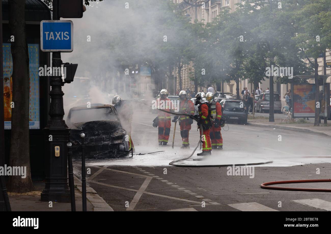 PARIS, FRANKREICH - 23. MAI 2020 : Unfall in den Straßen von Paris . Einige Feuerwehrleute löschen das Feuer das Auto in der Nähe des Triumphbogens in Paris. Stockfoto