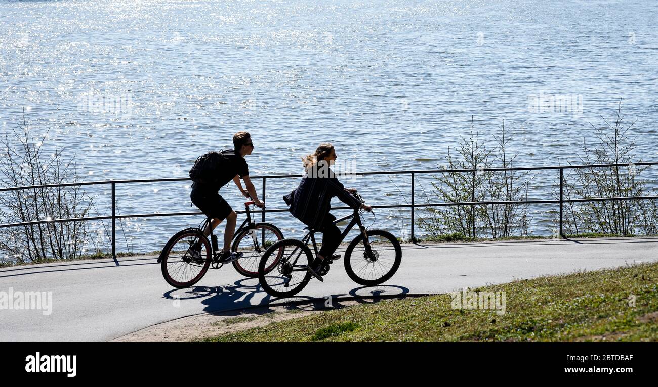 Münster, Nordrhein-Westfalen, Deutschland - Freizeit am Aasee in der Zeit der Corona-Krise fahren junge Menschen mit dem Fahrrad um die l Stockfoto