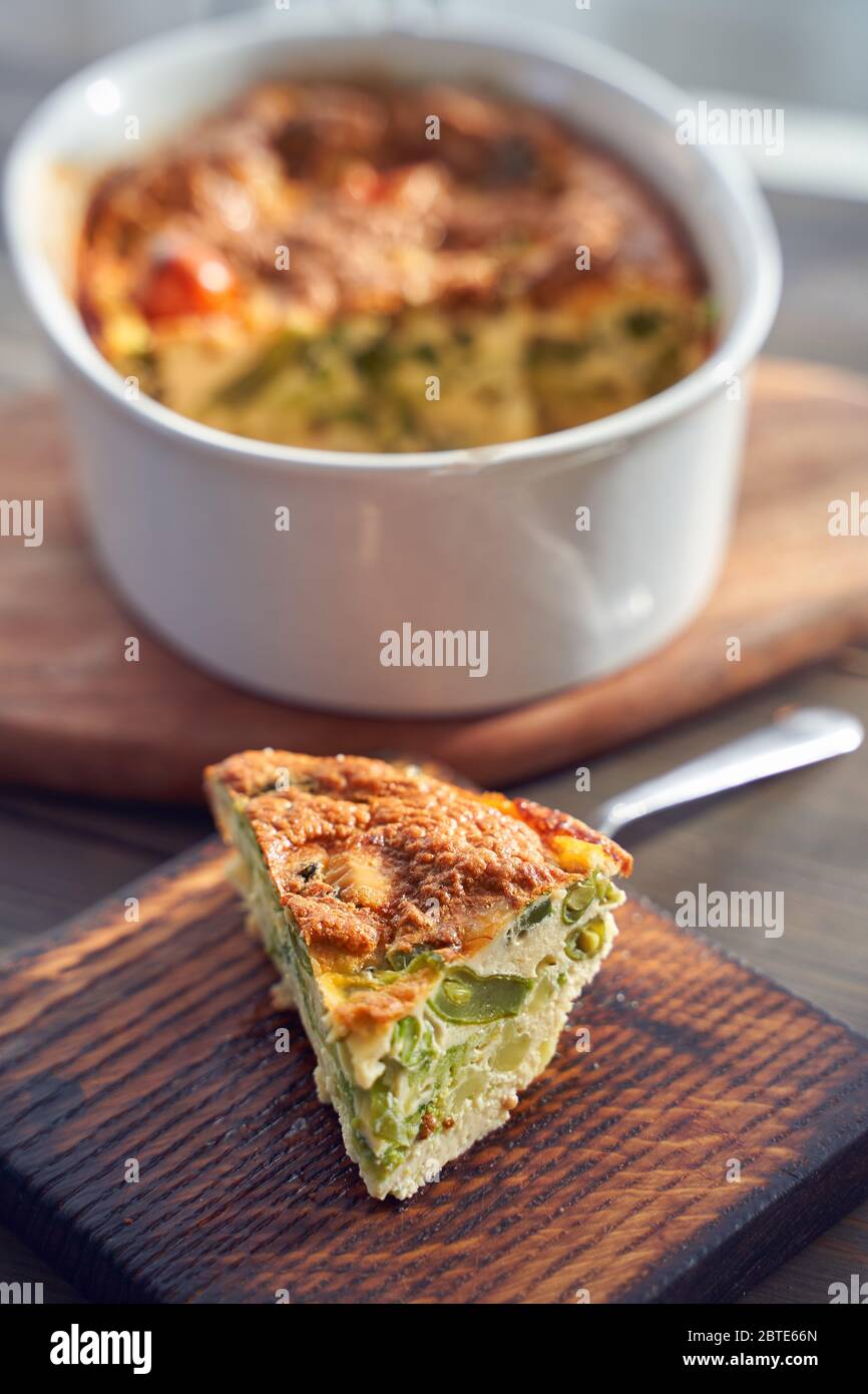 Brokkoli-Eierkäse-Auflauf in Backform auf Betongrund. Stockfoto