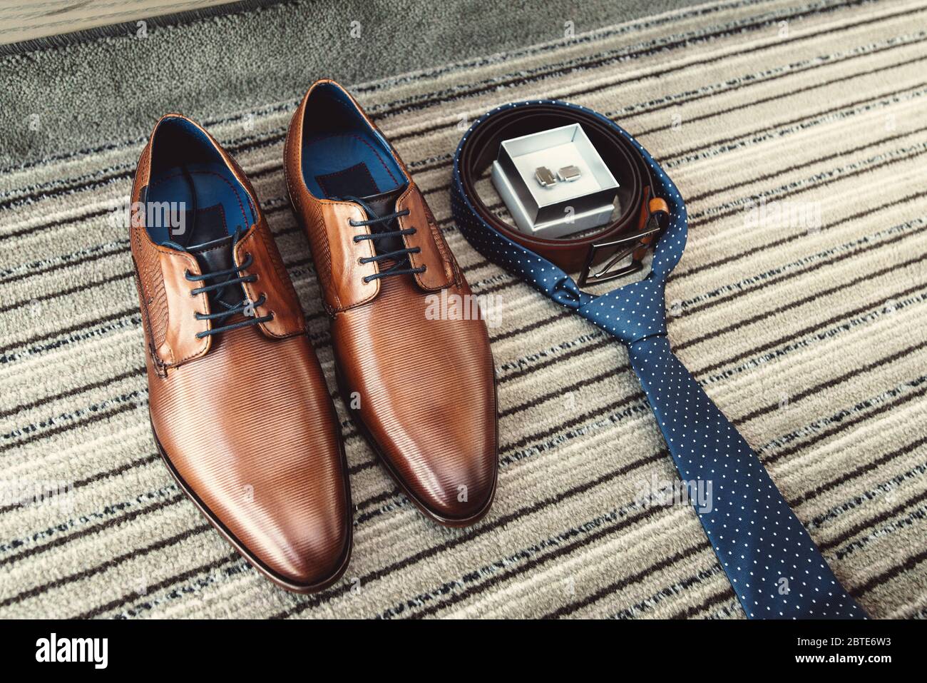 Braune Schuhe, blaue Krawatte, Gürtel und Manschettenknöpfe für den  Bräutigam Stockfotografie - Alamy